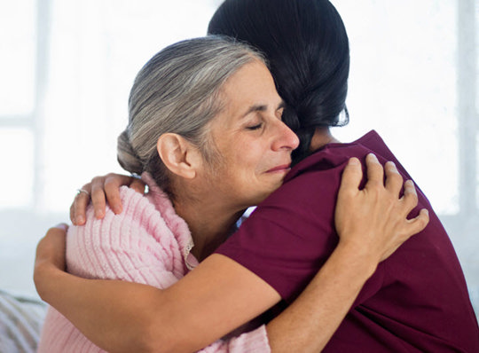 Nurse hugging a patient